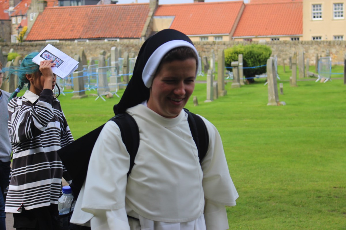 One of the Sisters at St Andrews smiling in spite of the weather